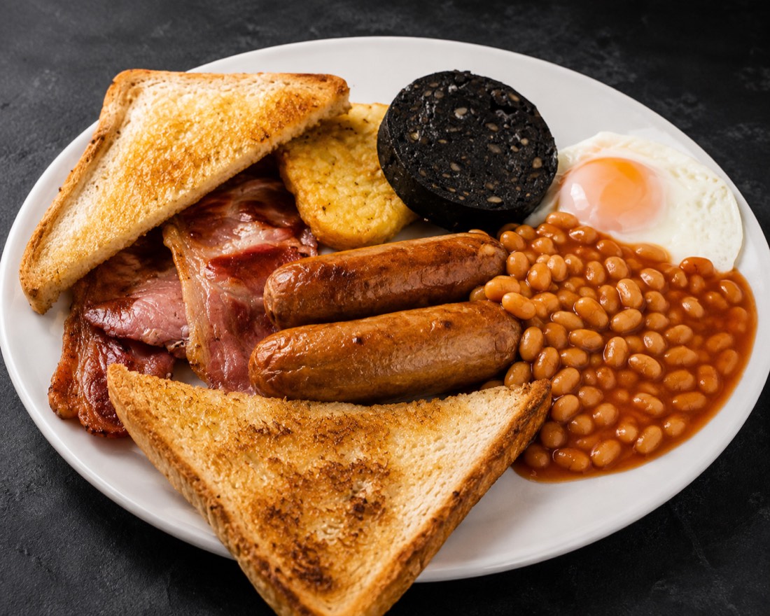 A full breakfast — bacon, sausages, fried egg, black pudding, hash brown, beans and toast